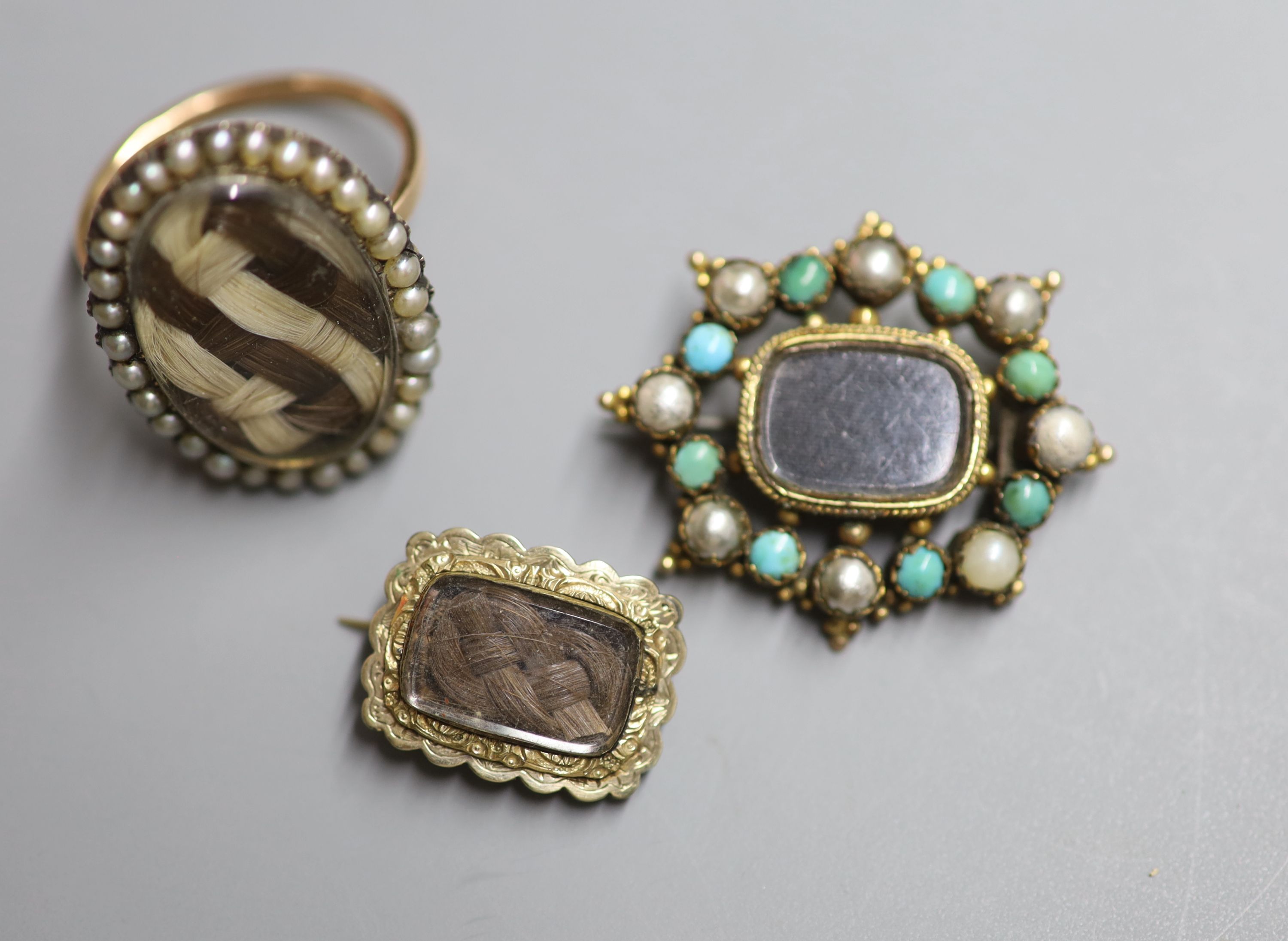 A 19th century yellow metal and seed pearl set oval mourning ring, with plaited hair below a glazed panel & 2 other items.